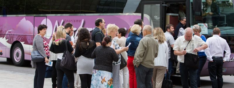 gens qui attendent de monter dans le bus de tourisme